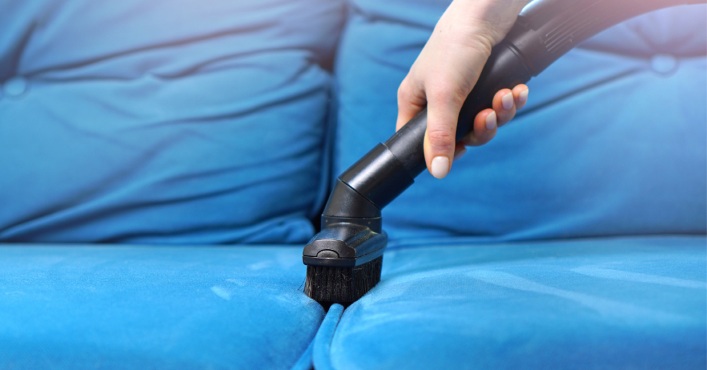 a recliner sofa being cleaned by a vacuum cleaner